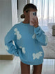 Women's patterned knit sweater with crew neck, long sleeves and contrasting motifs