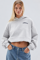 Women's oversized cropped hooded sweatshirt with long sleeves and chest text graphics