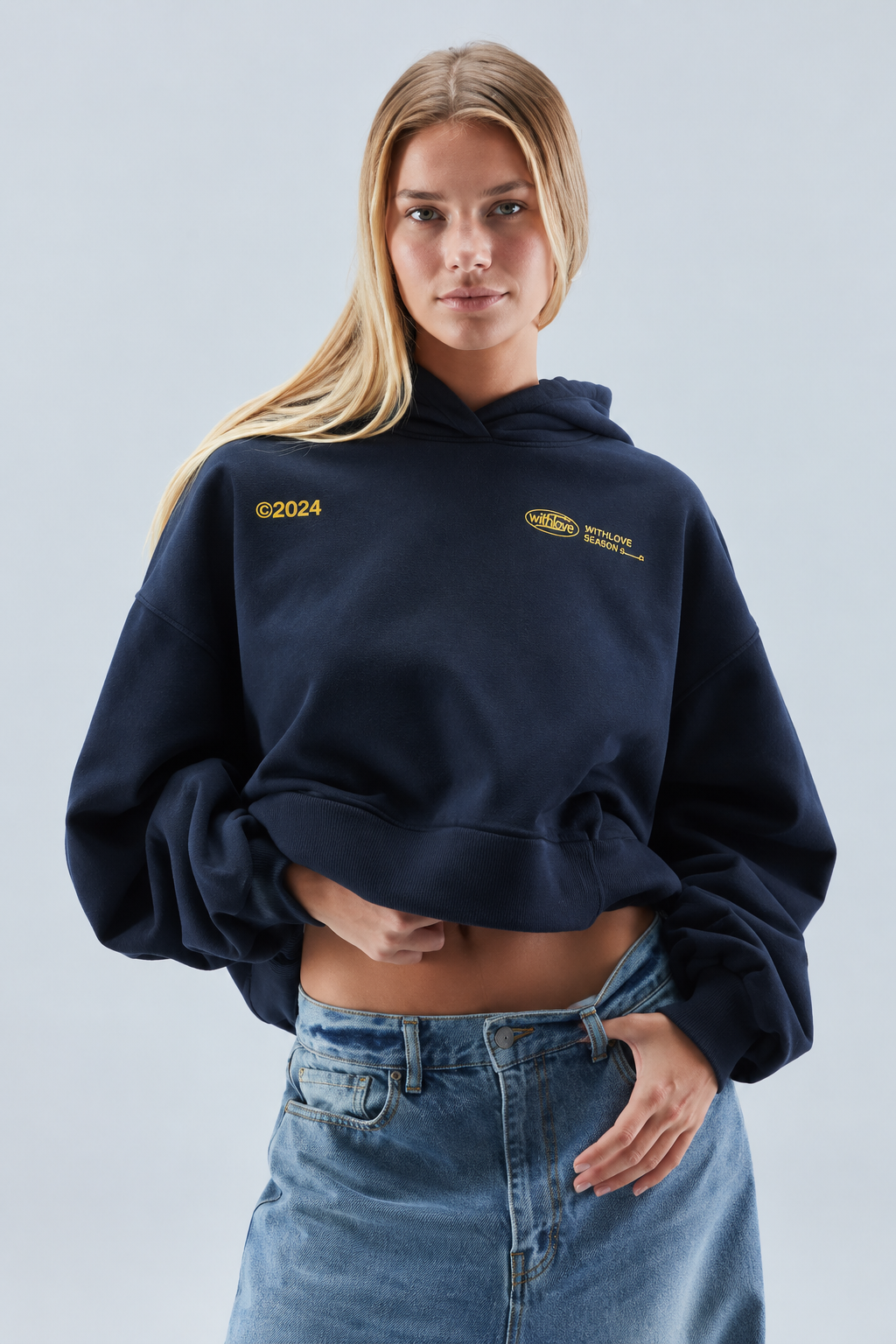 Women's oversized cropped hooded sweatshirt with long sleeves and chest text graphics