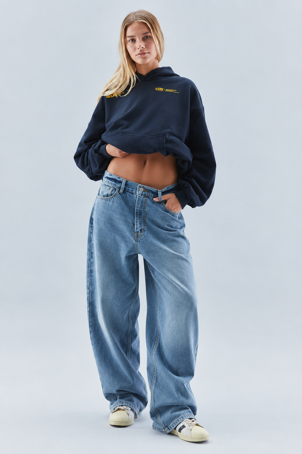Women's oversized cropped hooded sweatshirt with long sleeves and chest text graphics