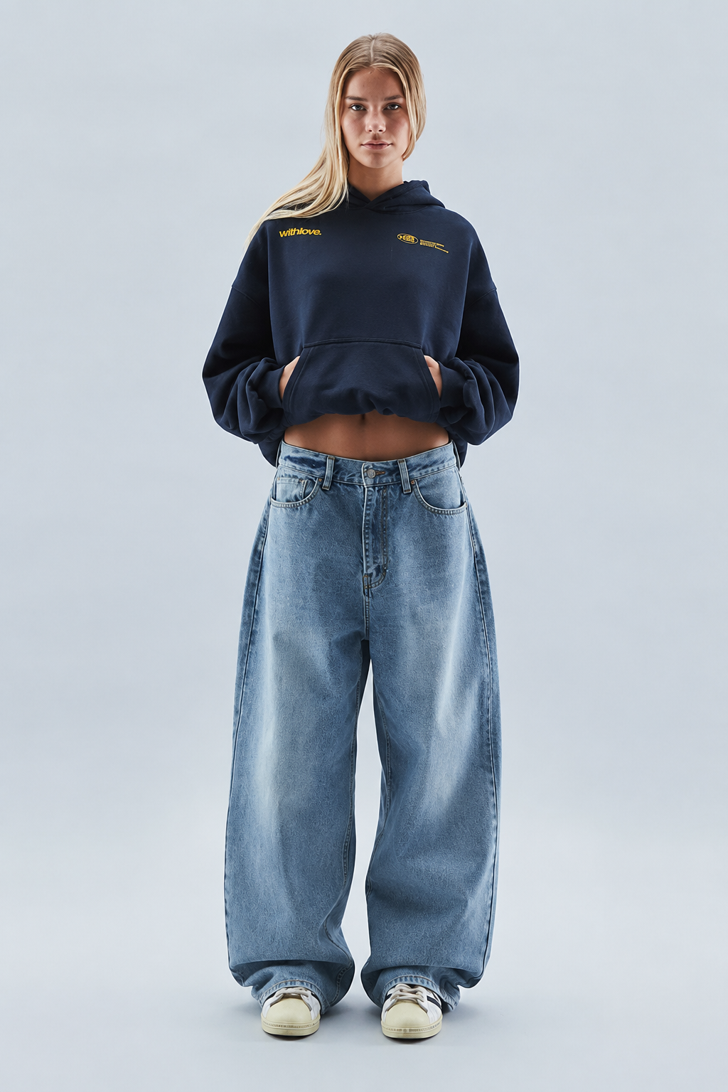Women's oversized cropped hooded sweatshirt with long sleeves and chest text graphics