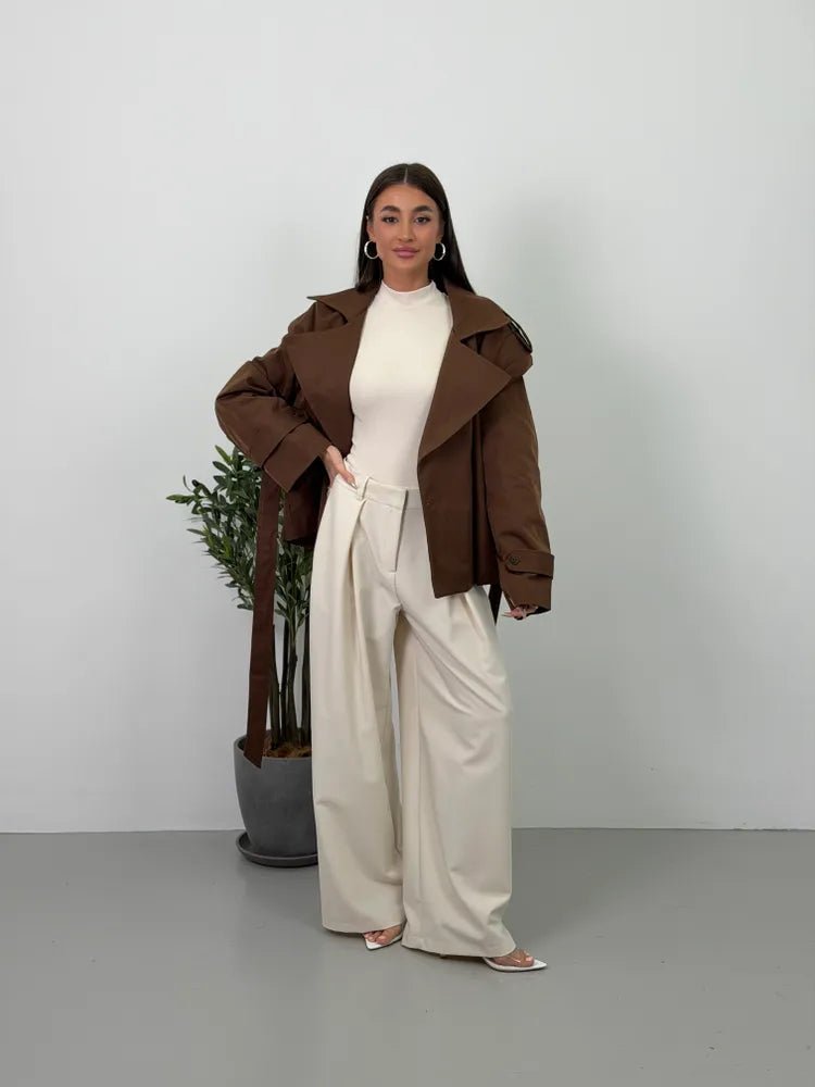 Women's brown cropped trench coat with wide lapels and belt