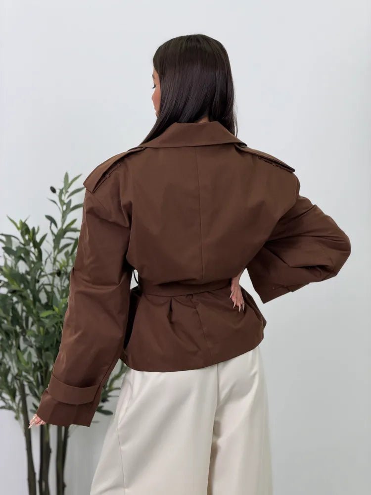 Women's brown cropped trench coat with wide lapels and belt