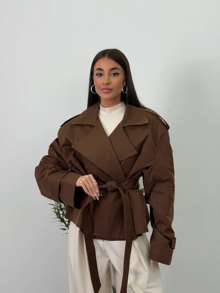 Women's brown cropped trench coat with wide lapels and belt