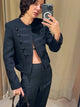 Women's black Napoleon jacket with high collar and multiple buttons