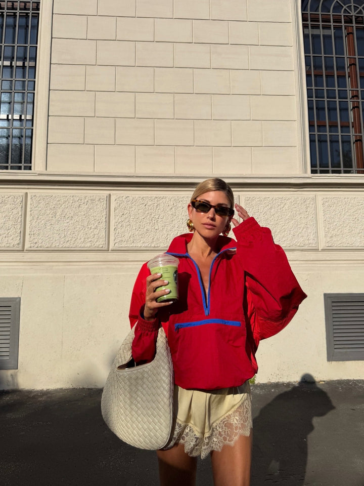 Women's orange and red colorblock half-zip windbreaker jacket
