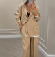 Women's blazer and wide-leg trousers suit set with notched lapels and button fastening