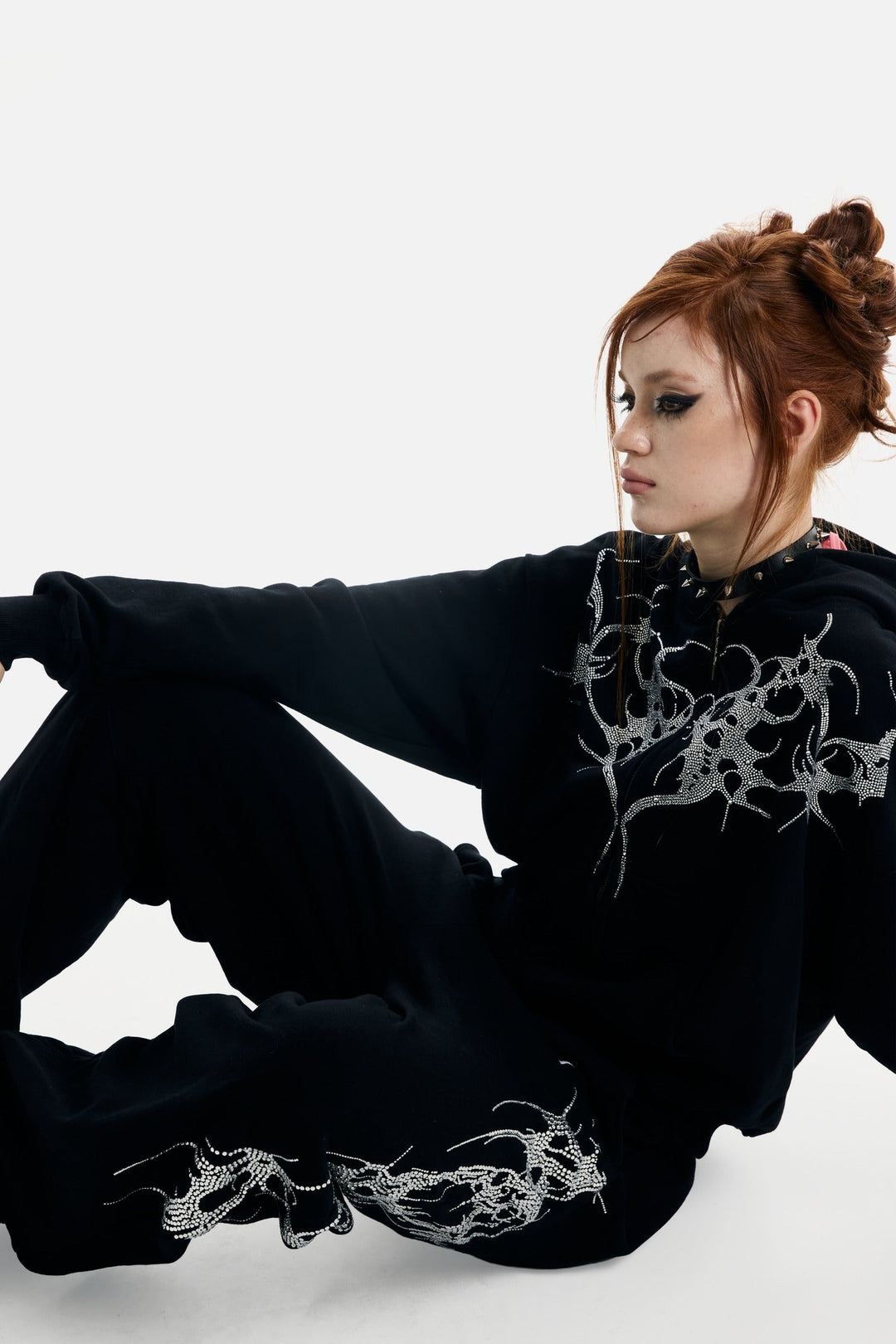Black hooded zip hoodie with silver rhinestone thorn and wing graphics