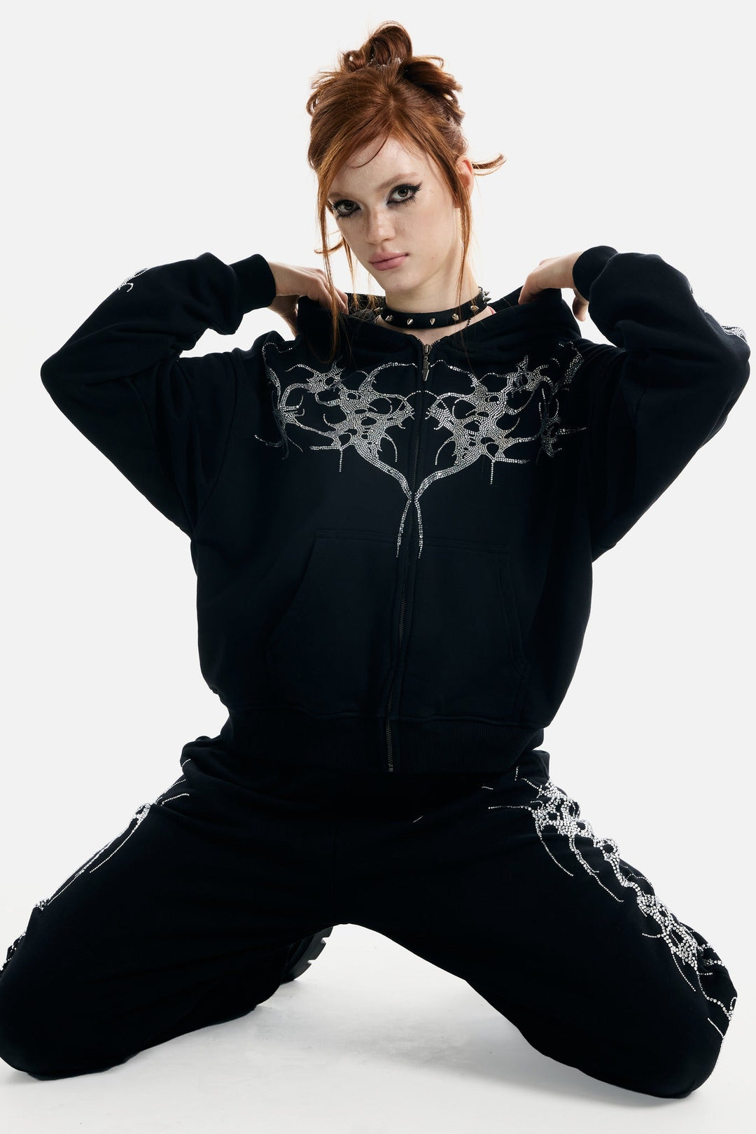 Black hooded zip hoodie with silver rhinestone thorn and wing graphics