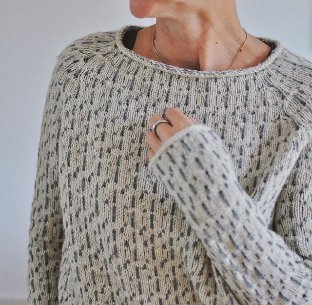 Women's gray textured knit sweater with crew neckline and long sleeves