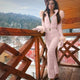 Women's quilted ski jumpsuit with belt and high collar