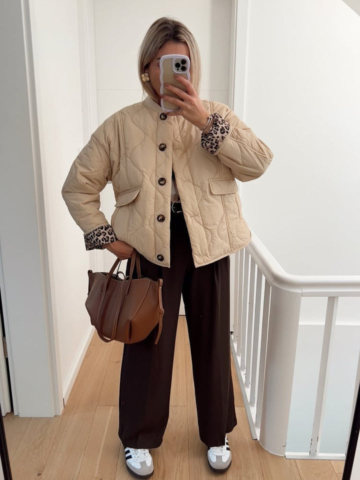Women's quilted jacket with button front and animal-print cuffs