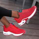 Women's red and white lace-up running trainers with cushioned soles