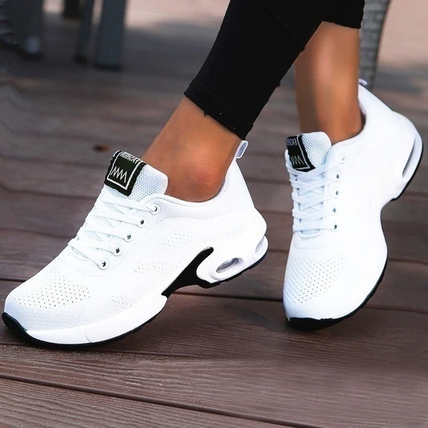 Women's red and white lace-up running trainers with cushioned soles