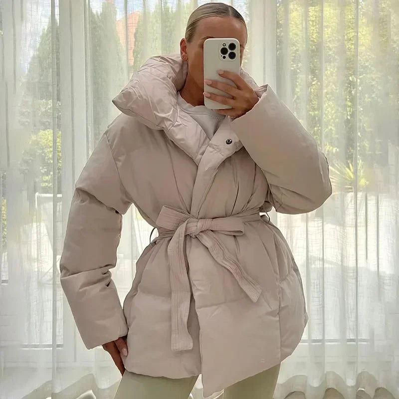 Women's quilted belted puffer parka with high collar and long sleeves
