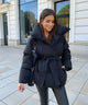 Women's quilted belted puffer parka with high collar and long sleeves
