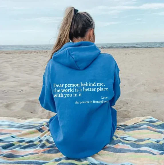 Women's relaxed hooded sweatshirt with contrasting text graphic on the back