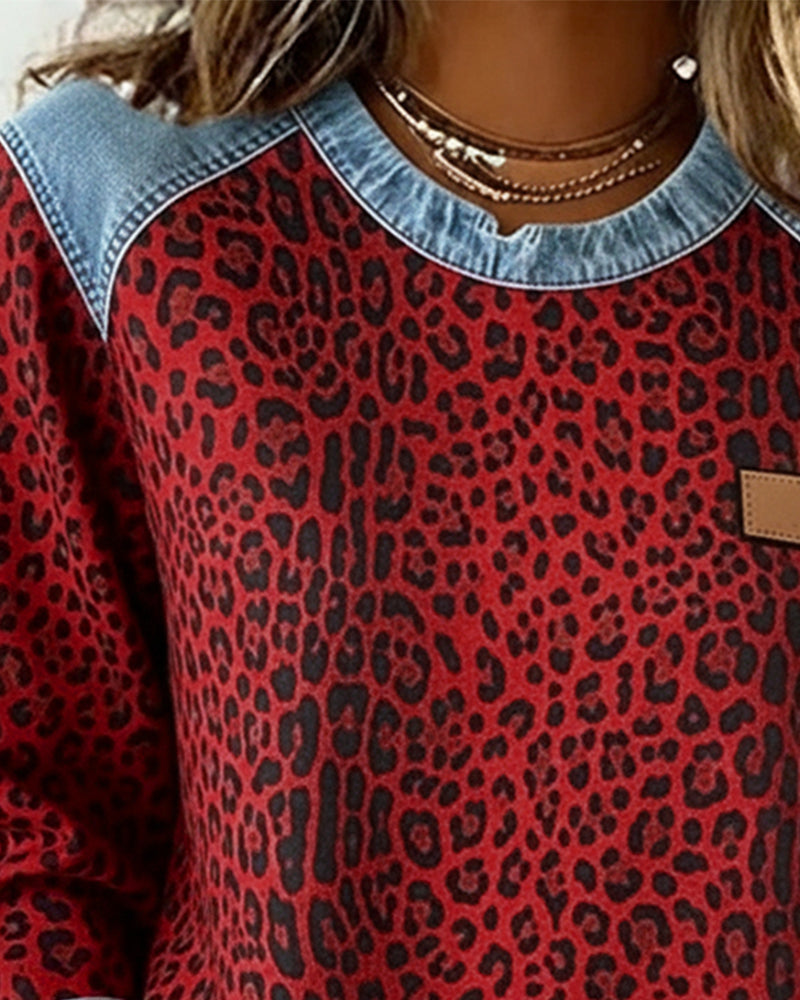 Women's leopard print sweatshirt with denim-style patchwork trim and long sleeves