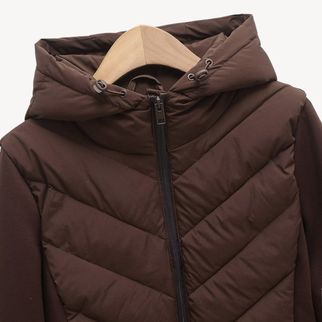 Women's hooded quilted jacket with chevron front, long sleeves and zip fastening