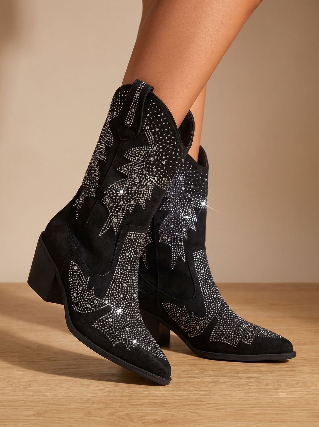 Black pointed-toe cowboy boots with silver rhinestone motifs and block heels