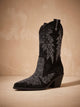 Black pointed-toe cowboy boots with silver rhinestone motifs and block heels