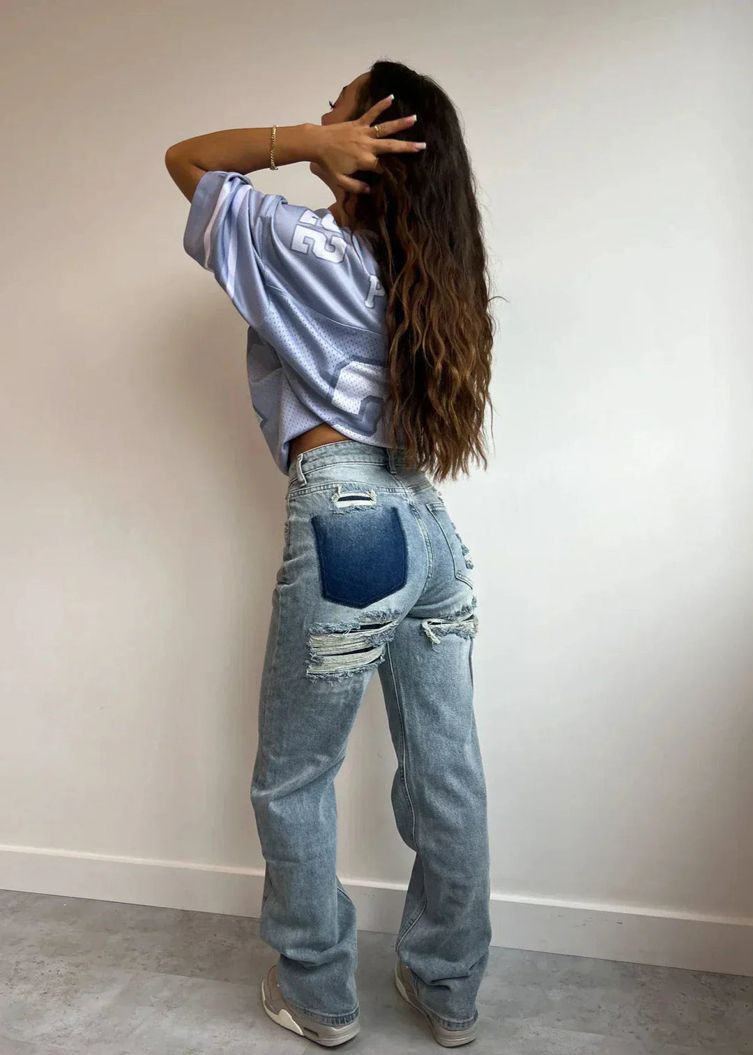 Women's high-waist straight-leg jeans with distressed rips and five pockets