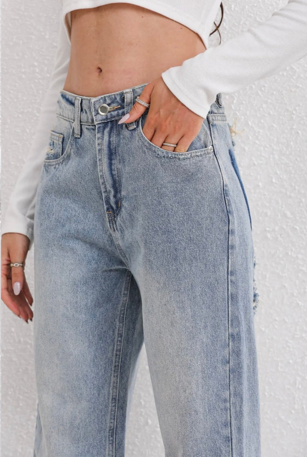 Women's high-waist straight-leg jeans with distressed rips and five pockets