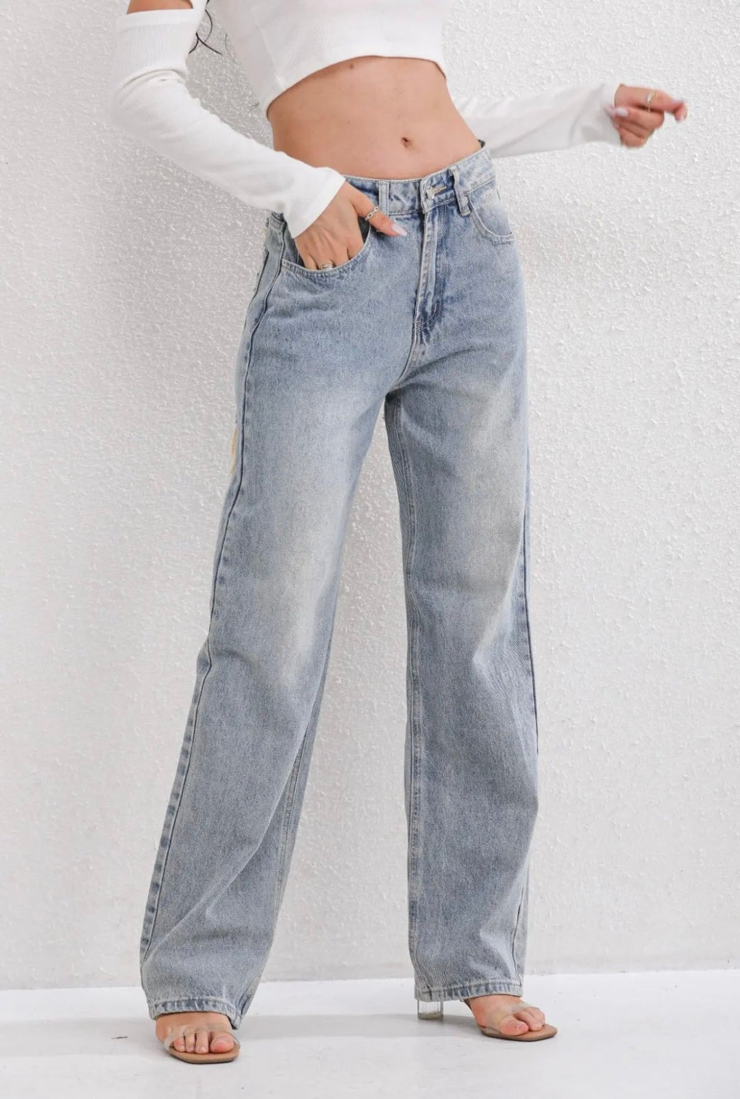 Women's high-waist straight-leg jeans with distressed rips and five pockets